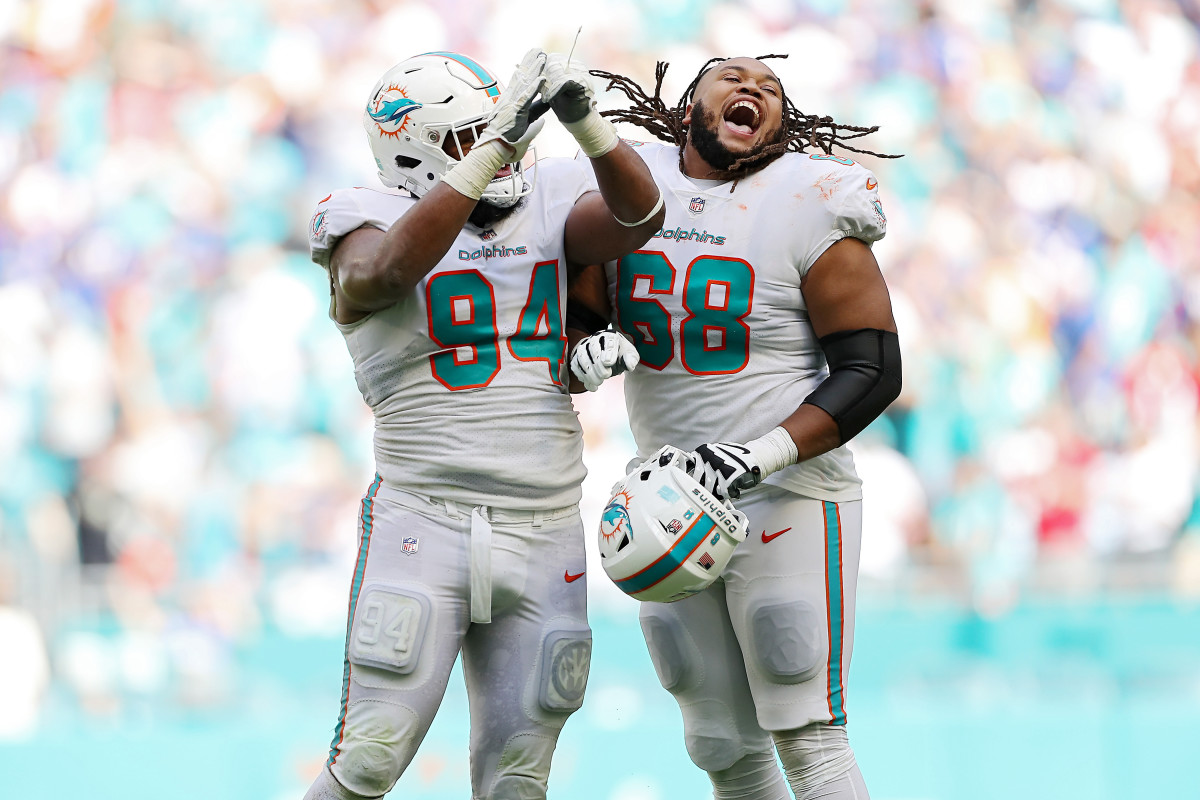 Christian Wilkins and Robert Hunt celebrate the Dolphins' win over the Bills.