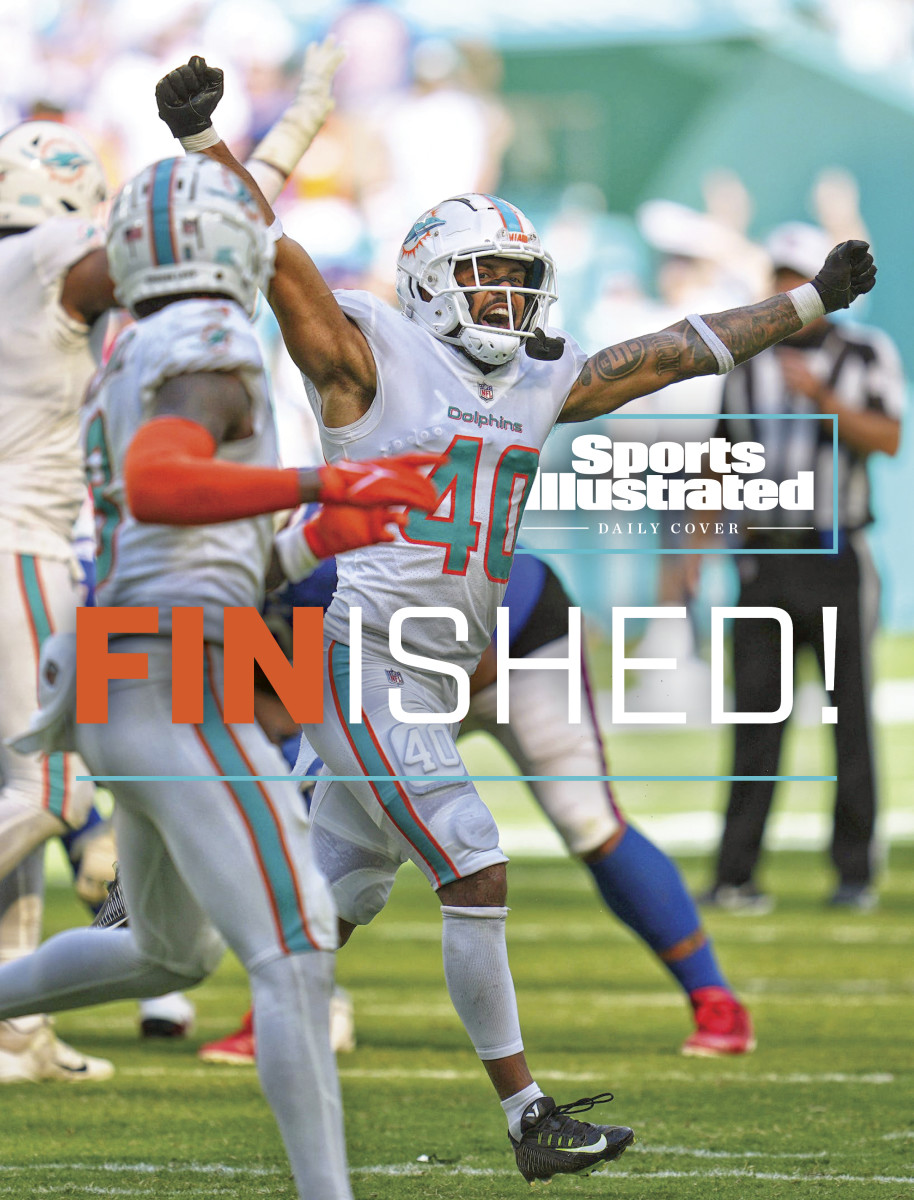 Dolphins players run off the field celebrating after defeating the Bills
