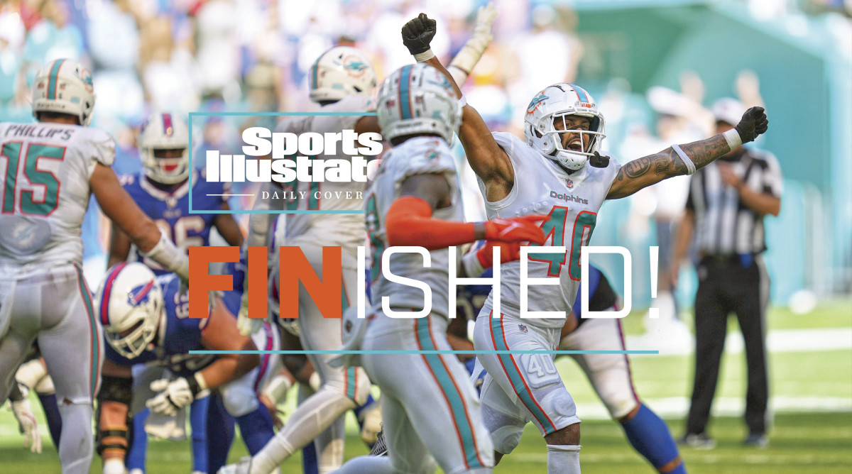 Dolphins players run off the field after defeating the Bills