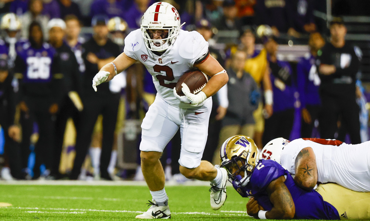 Stanford running back Casey Filkins breaks away from a Washington defender.