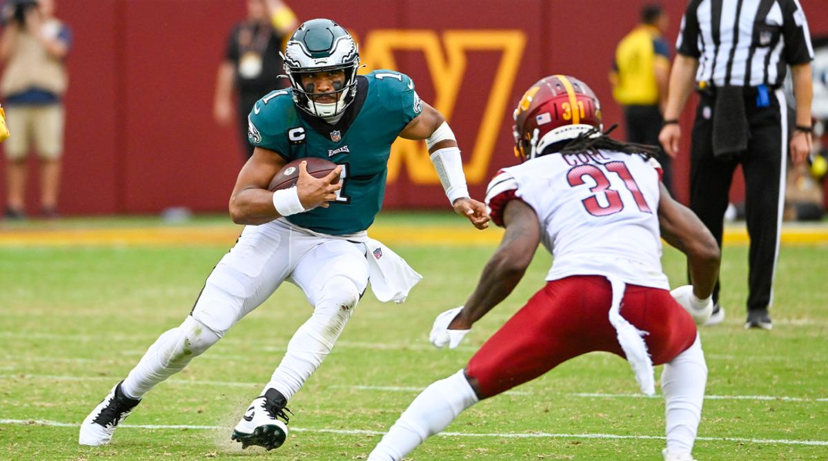 Sep 25, 2022; Landover, Maryland, USA; Philadelphia Eagles quarterback Jalen Hurts (1) carries the ball as Washington Commanders safety Kamren Curl (31) defends during the second half at FedExField.