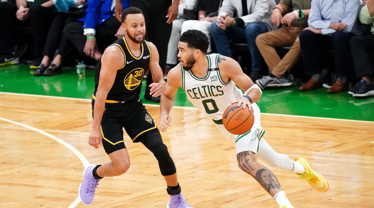 Jun 10, 2022; Boston, Massachusetts, USA; Boston Celtics forward Jayson Tatum (0) dribbles the ball against Golden State Warriors guard Stephen Curry (30) during the fourth quarter of game four in the 2022 NBA Finals at the TD Garden.