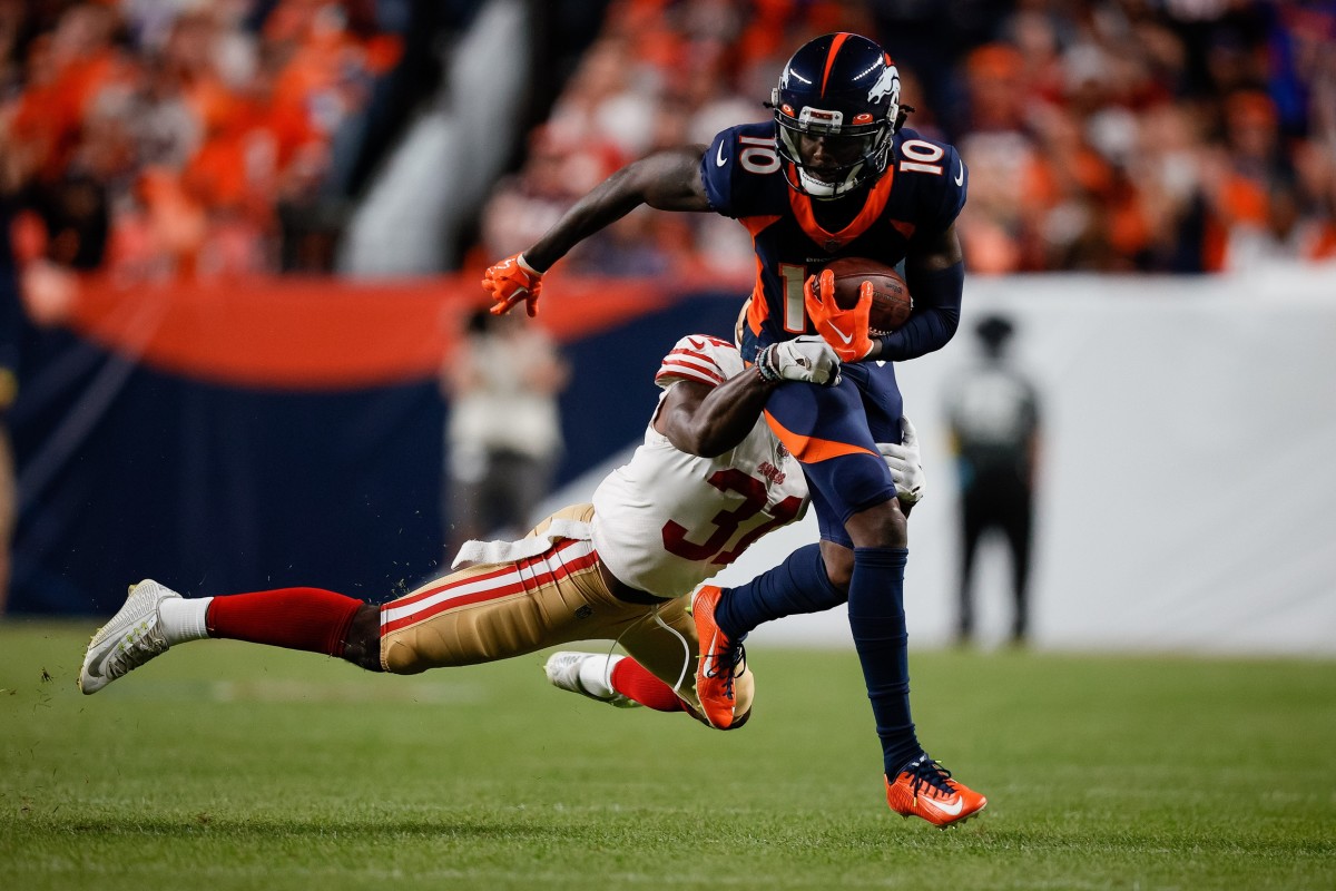 Denver Broncos wide receiver Jerry Jeudy (10) is tackled by San Francisco 49ers safety Tashaun Gipson Sr. (31) in the second quarter at Empower Field at Mile High.
