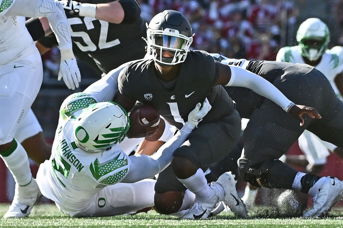 Washington State Cougars quarterback Cameron Ward (1) is sacked by Oregon Ducks linebacker DJ Johnson (2) in the second half at Gesa Field at Martin Stadium. Ducks won 44-41.