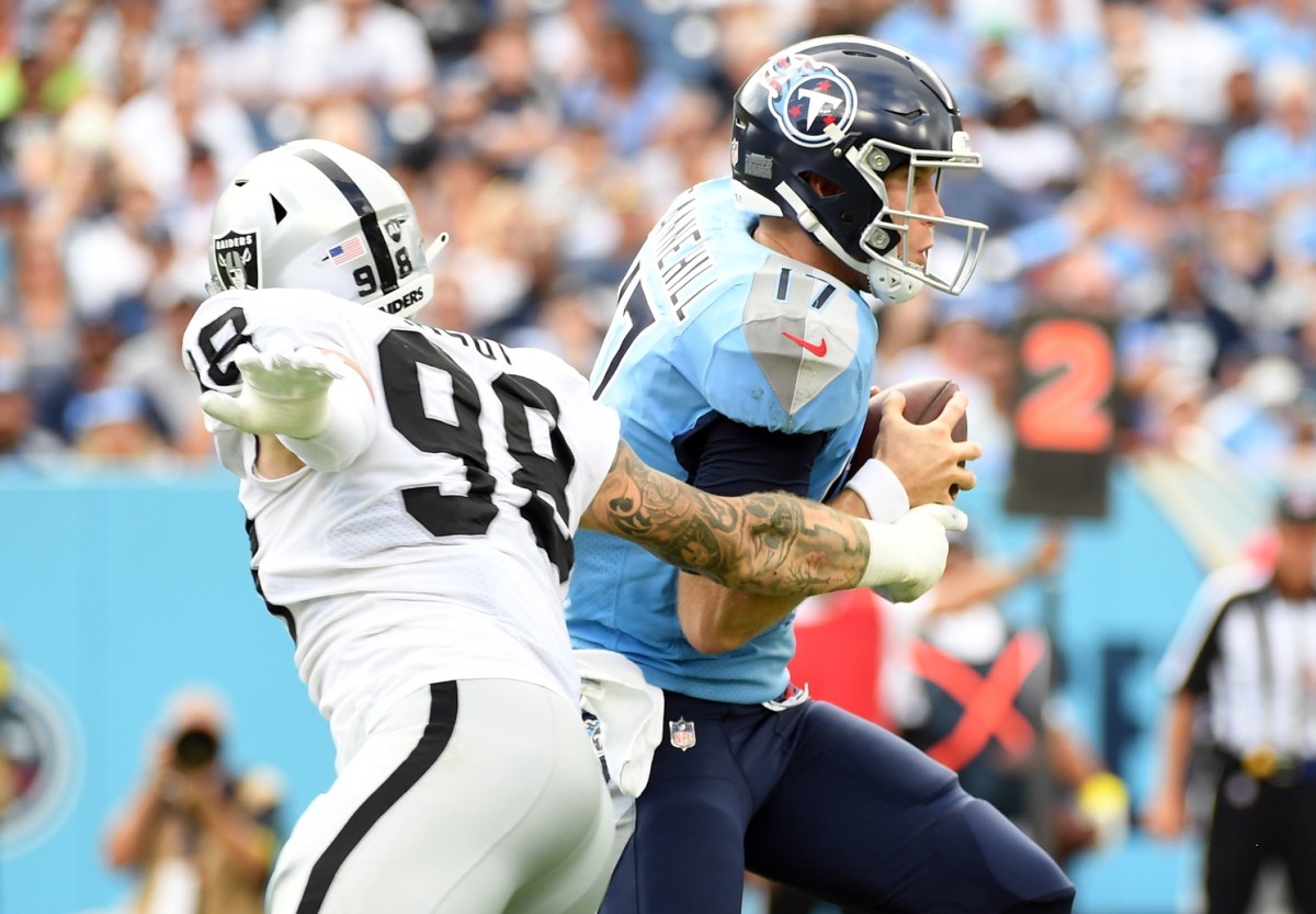Sep 25, 2022; Nashville, Tennessee, USA; Tennessee Titans quarterback Ryan Tannehill (17) moves the ball against Las Vegas Raiders defensive end Maxx Crosby (98) during the second half at Nissan Stadium. Mandatory Credit: Christopher Hanewinckel-USA TODAY Sports