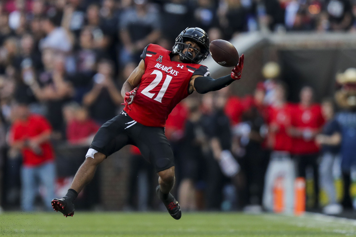 Sep 24, 2022; Cincinnati, Ohio, USA; Cincinnati Bearcats wide receiver Tyler Scott (21) attempts to catch a pass against the Indiana Hoosiers in the second half at Nippert Stadium. Mandatory Credit: Katie Stratman-USA TODAY Sports