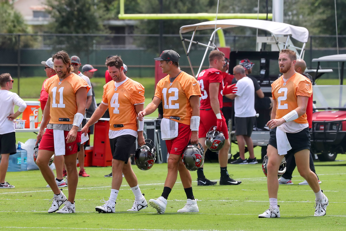 Bucs quarterbacks Blaine Gabbert, Ryan Griffin, Tom Brady and Kyle Trask walk into the field during training camp.