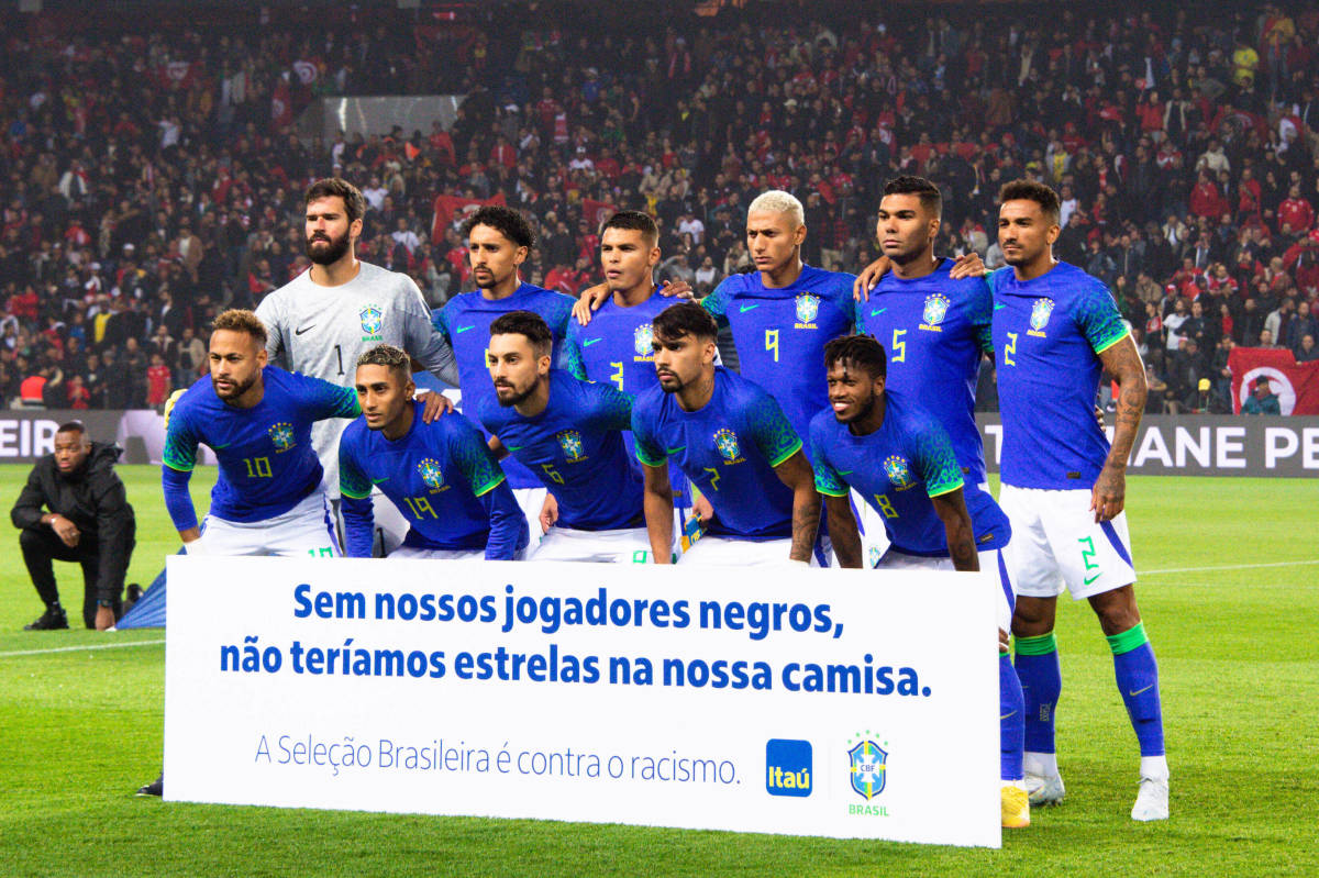 Brazil's players pictured posing in September 2022 with a banner that read: "Without our black players, we wouldn't have stars on our shirt"