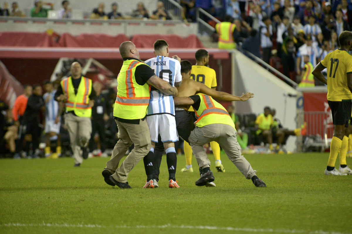 Security staff pictured intervening after a pitch invader had approached Lionel Messi (center) during a game between Argentina and Jamaica in New Jersey in September 2022