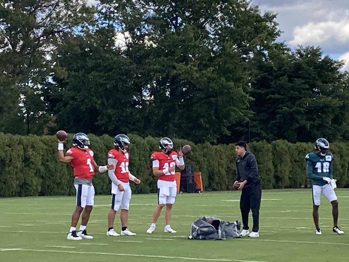 Eagles QBs, from left to right, Jalen Hurts, Gardner Minshew, and Ian Book warm up for practice on Sept. 28, 2022