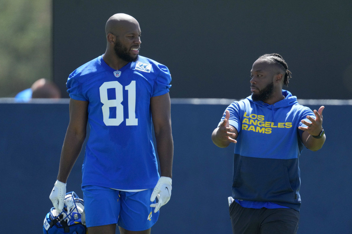 Rams tight end Jamal Pettigrew talks to tight ends coach Thomas Brown during minicamp.