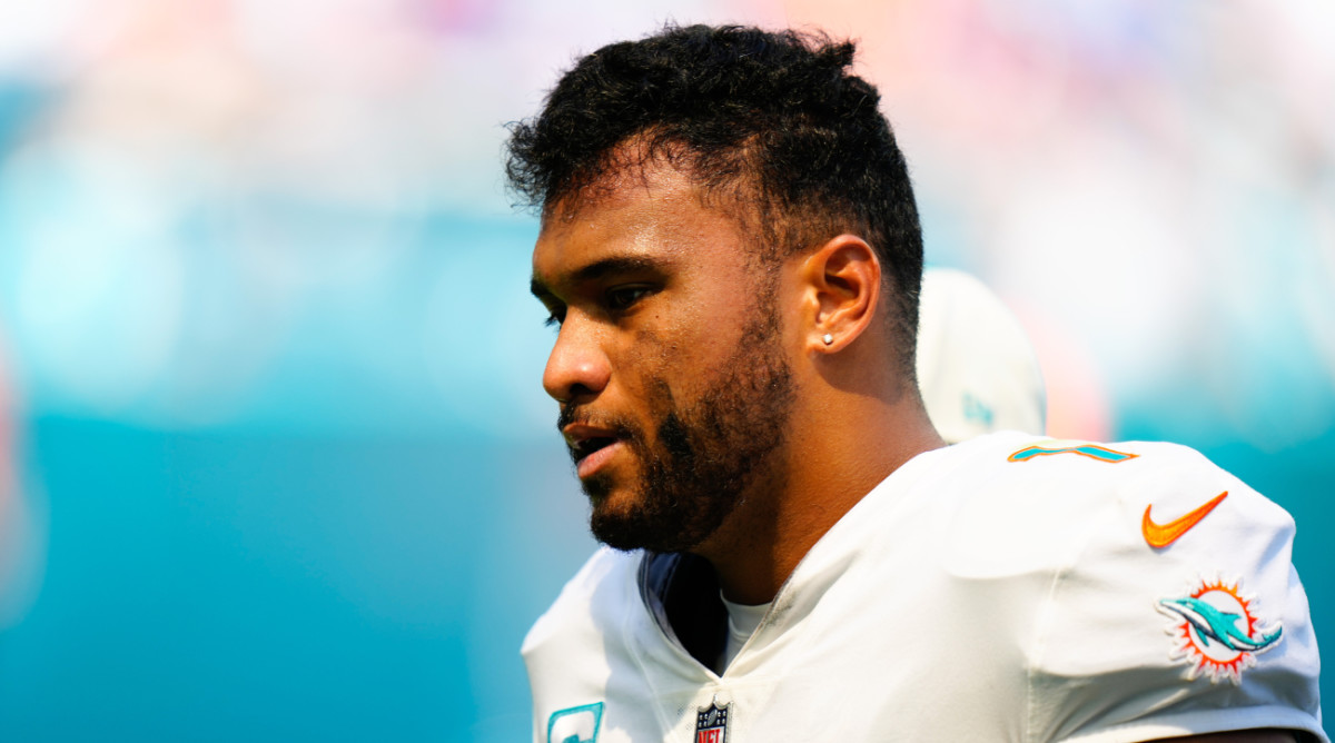 Miami Dolphins quarterback Tua Tagovailoa (1) is helped off the field by staff after a apparent injury against the Buffalo Bills on Sept. 25, 2022.