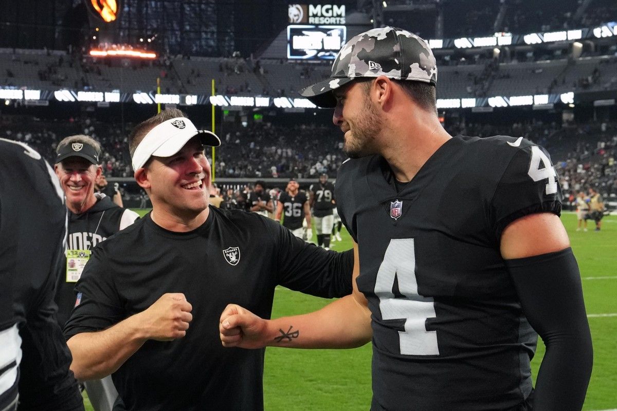 Las Vegas Raiders coach Josh McDaniels (left) and quarterback Derek Carr (4) celebrate after the game against the New England Patriots at Allegiant Stadium.