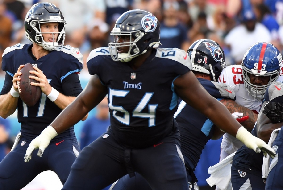 Tennessee Titans quarterback Ryan Tannehill (17) drops back to pass with protection from guard Nate Davis (64) during the first half against the New York Giants at Nissan Stadium.