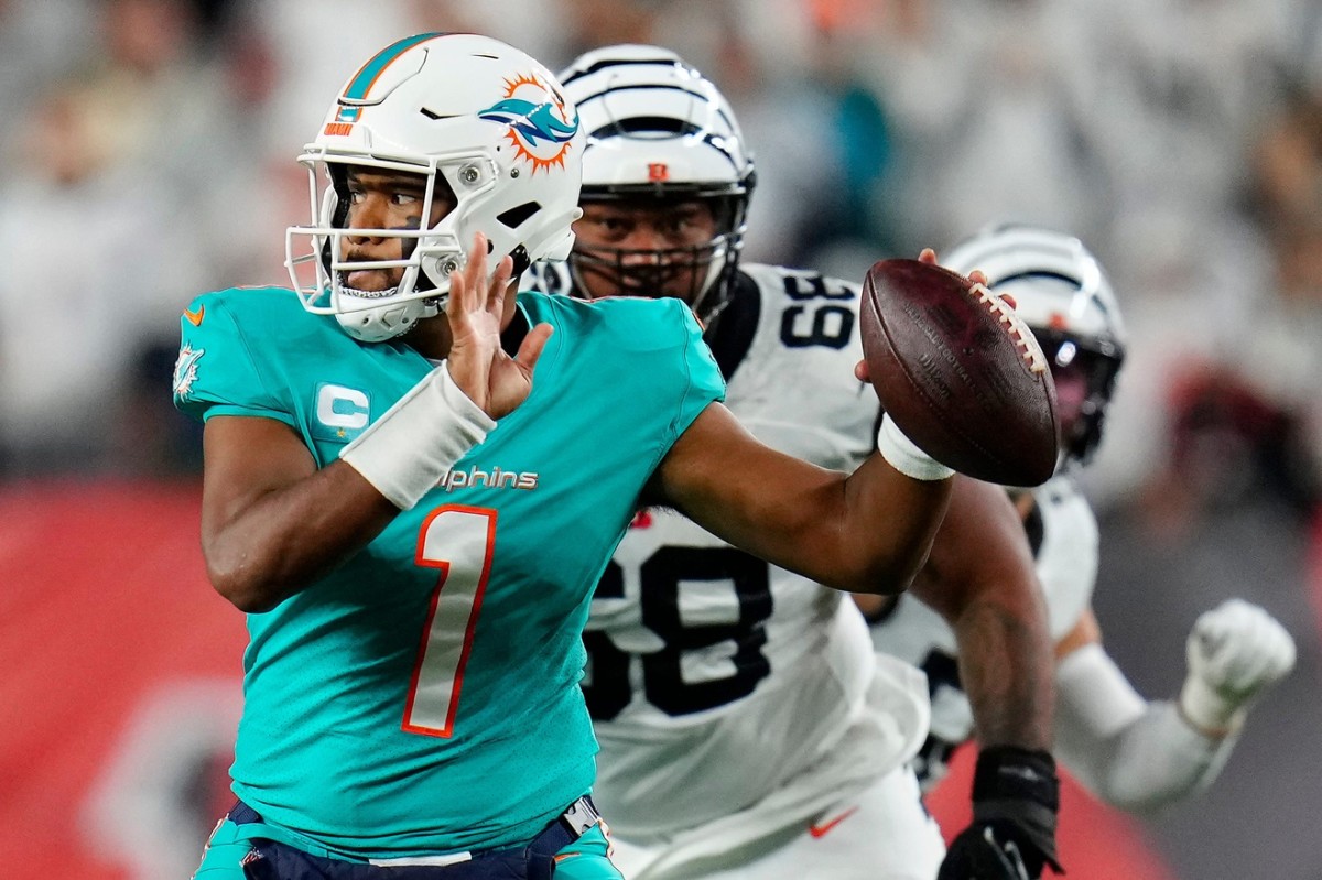 Miami Dolphins quarterback Tua Tagovailoa (1) is pursued by Cincinnati Bengals defensive tackle Josh Tupou (68) in the second quarter of the NFL Week 4 game between the Cincinnati Bengals and the Miami Dolphins at PayCor Stadium in downtown on Thursday, Sept. 29, 2022.