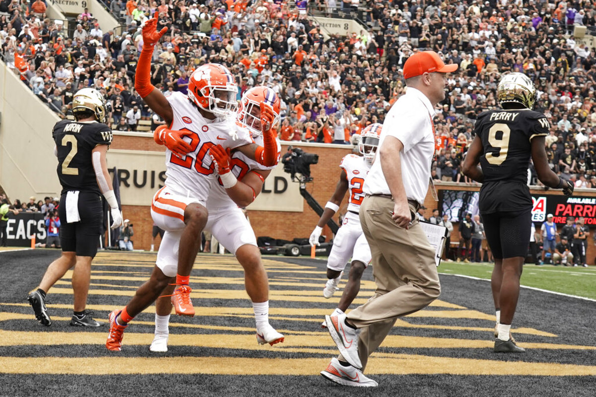 Clemson cornerback Nate Wiggins (20) is congratulated by teammate Keith Maguire (30) after knocking down a fourth down pass intended for Wake Forest wide receiver A.T. Perry (9) during the second overtime of an NCAA college football game in Winston-Salem, N.C., Saturday, Sept. 24, 2022. Clemson won 51-45 in double overtime. (AP Photo/Chuck Burton)