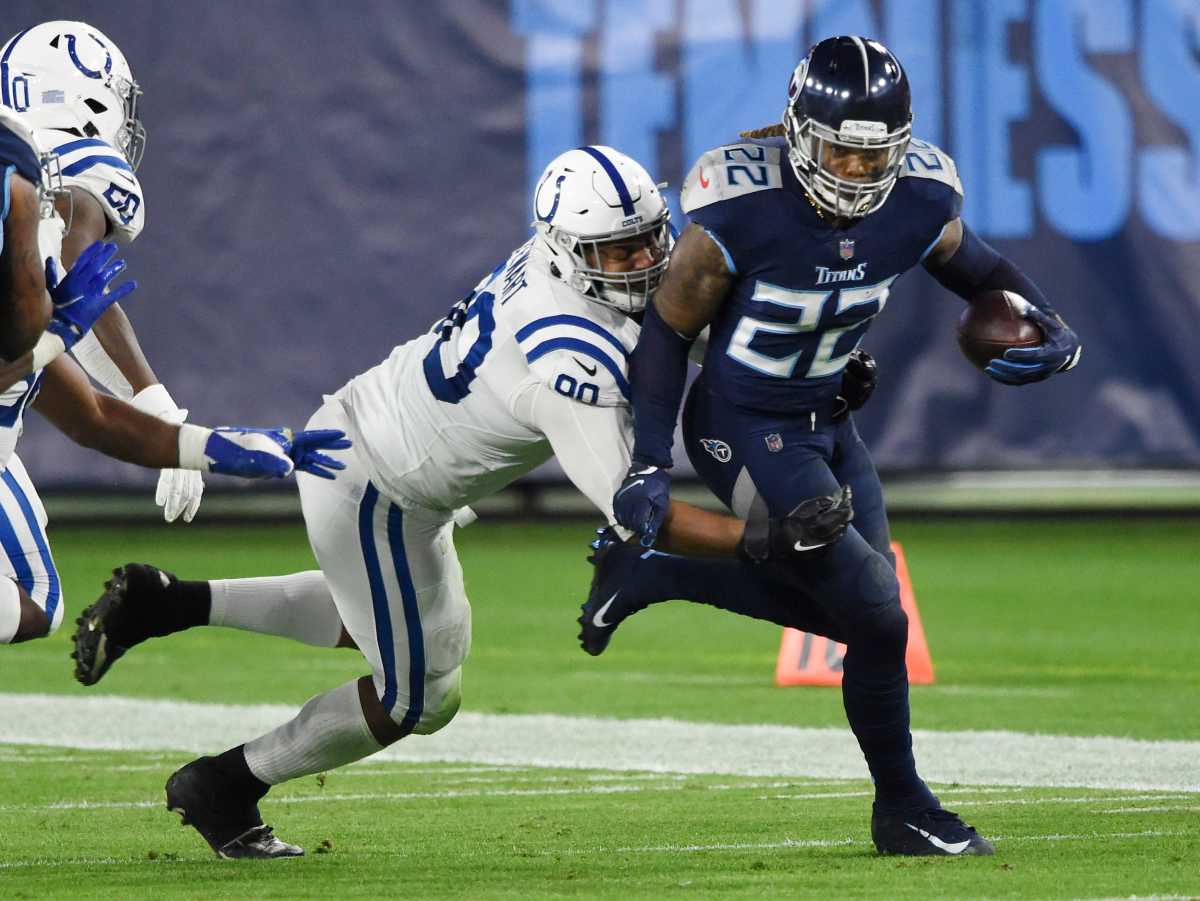 Tennessee Titans running back Derrick Henry (22) races up the field with Indianapolis Colts defensive tackle Grover Stewart (90) on his back during the second quarter at Nissan Stadium Thursday, Nov. 12, 2020 in Nashville, Tenn. Gw44714