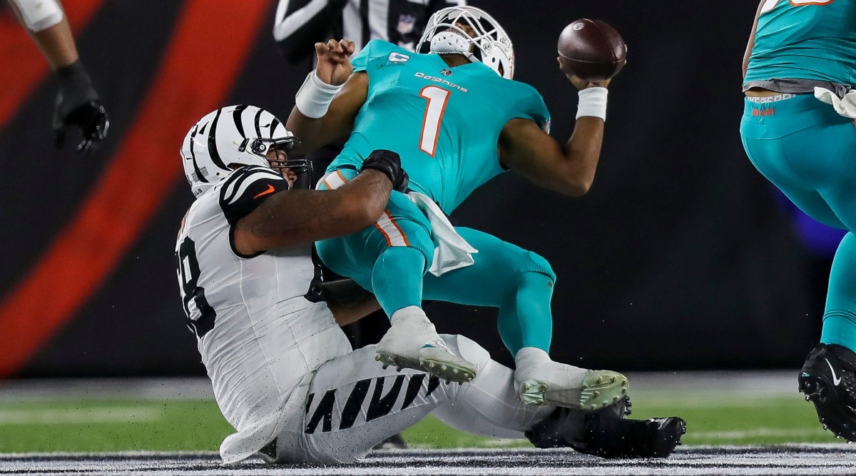 Bengals defensive tackle Josh Tupou (68) sacks Miami Dolphins quarterback Tua Tagovailoa (1) in the first half at Paycor Stadium. Tagovailoa sustained a head injury on the play and left the game for treatment.