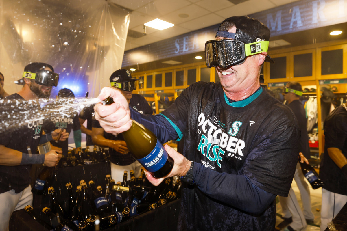 Sep 30, 2022; Seattle, Washington, USA; Seattle Mariners manager Scott Servais (9) celebrates in the clubhouse following a 2-1 victory against the Oakland Athletics to clinch a wild card playoff berth at T-Mobile Park.