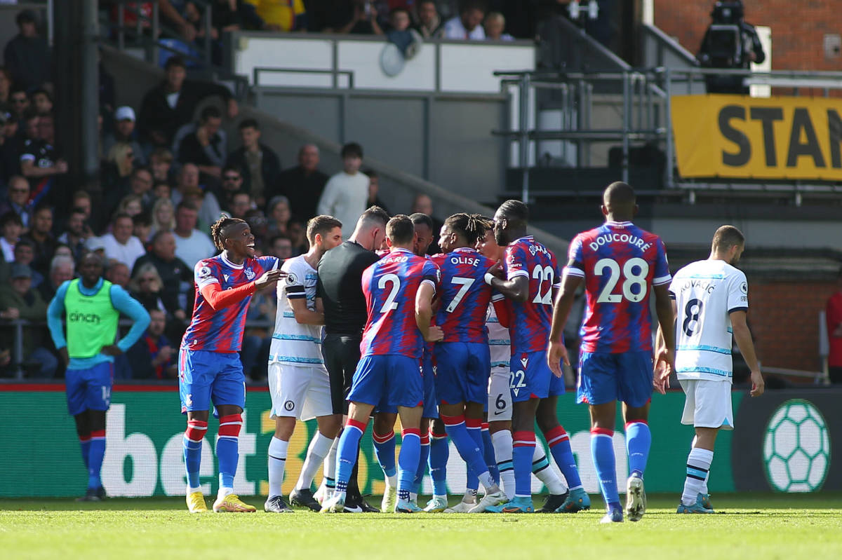 Players from both teams are pictured surrounding referee Chris Kavanagh during Chelsea's 2-1 win at Crystal Palace in October 2022 after a handball offense by no.6 Thiago Silva