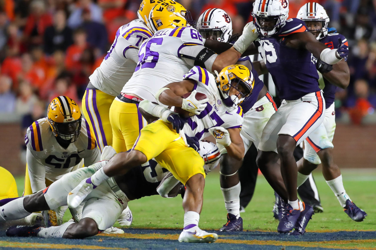 LSU Tigers running back Josh Williams (27) gets dragged down by the Auburn defender during the game between the LSU Tigers and the Auburn Tigers at Jordan-Hare Stadium on Oct. 1, 2022.