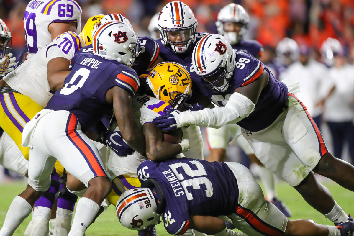 The LSU Tigers ball carrier gets tackled by a host of Auburn Tigers during the game between the LSU Tigers and the Auburn Tigers at Jordan-Hare Stadium on Oct. 1, 2022.