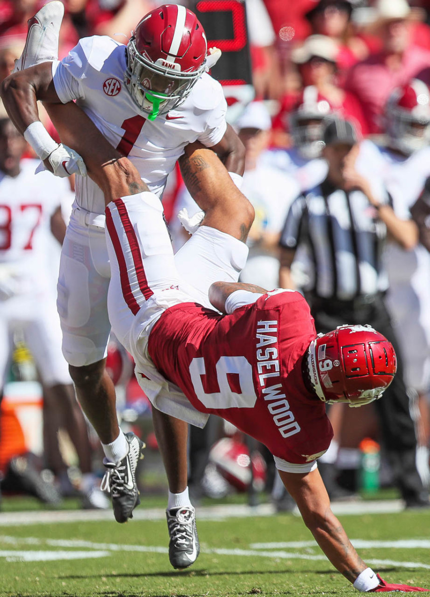 Arkansas wide receiver Jadon Haselwood is dumped onto his shoulder in a home game against Alabama. 