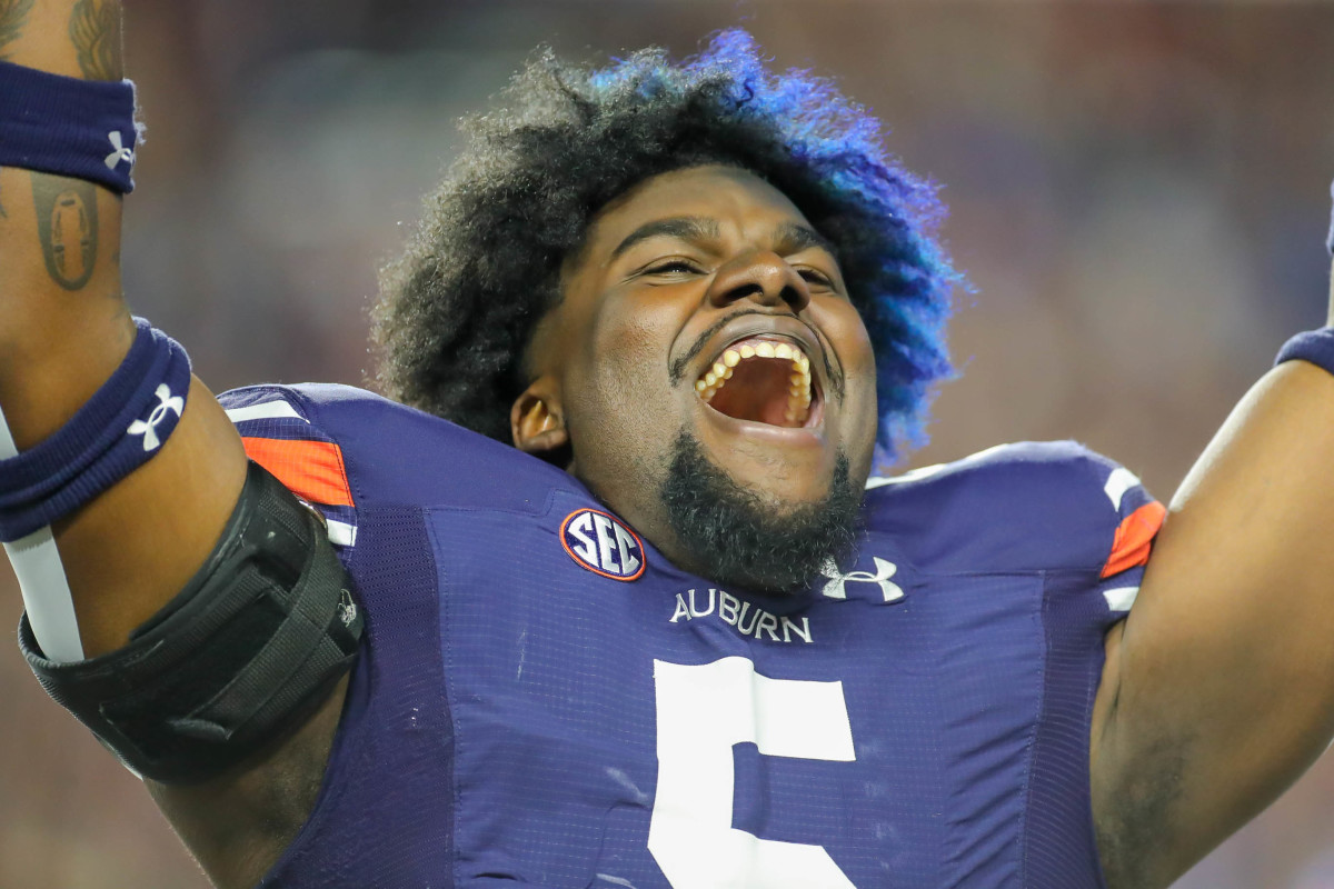 Auburn Tigers defensive lineman Jeffrey M'Ba (5) celebrates on the sideline after an Auburn score during the game between the LSU Tigers and the Auburn Tigers at Jordan-Hare Stadium on Oct. 1, 2022.