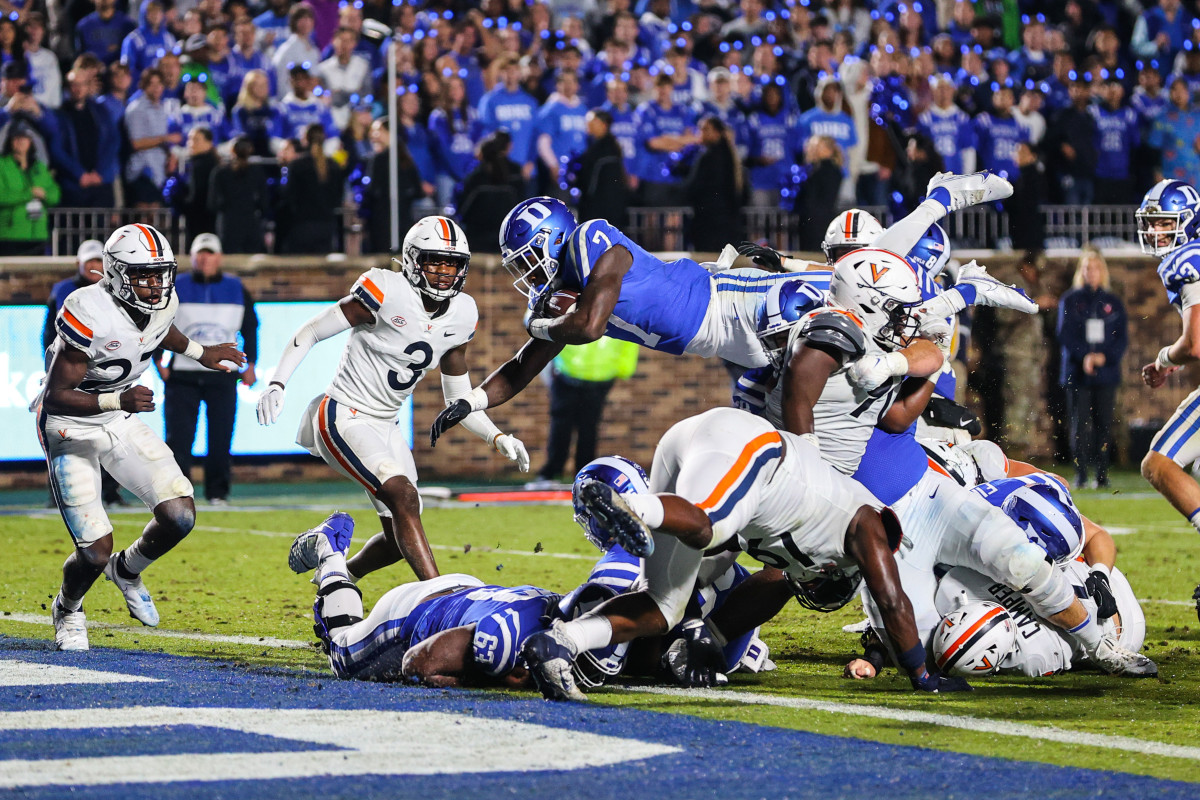 Duke Blue Devils running back Jordan Waters (7) jumps to score a touchdown against the Virginia Cavaliers during the first half at Wallace Wade Stadium.