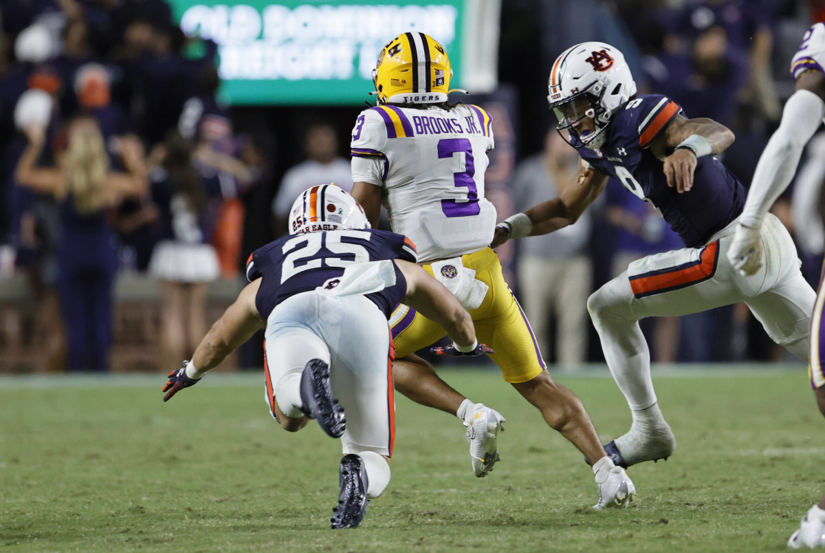 Oct 1, 2022; Auburn, Alabama, USA; LSU Tigers safety Greg Brooks Jr. (3) is tackled by Auburn Tigers quarterback Robby Ashford (9) and tight end John Samuel Shenker (25) after intercepting a pass by Ashford during the fourth quarter at Jordan-Hare Stadium. Mandatory Credit: John Reed-USA TODAY Sports