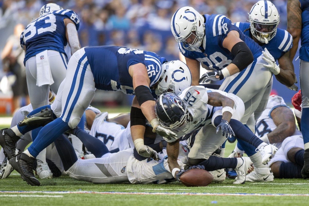 Tennessee Titans cornerback Kristian Fulton (26) goes for a loose ball in front of Indianapolis Colts guard Quenton Nelson (56) during the second half at Lucas Oil Stadium.