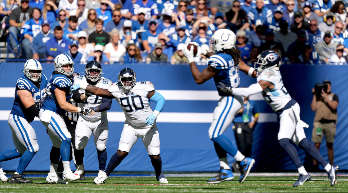 Oct 2, 2022; Indianapolis, Indiana, USA; Tennessee Titans defensive end Kevin Strong (97) and defensive tackle Naquan Jones (90) and Indianapolis Colts guard Quenton Nelson (56) and offensive tackle Luke Tenuta (76) watch as Indianapolis Colts tight end Mo Alie-Cox (81) makes a catch during the second half at Lucas Oil Stadium.