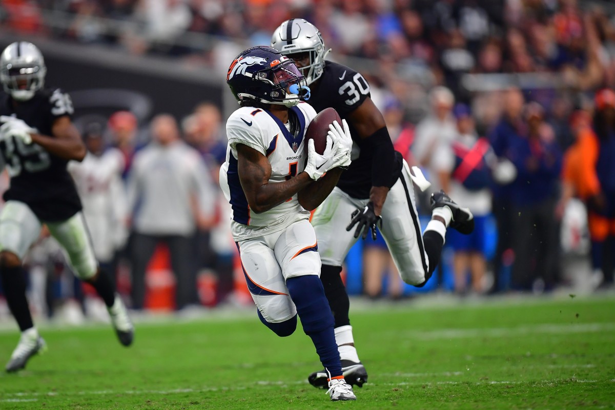 Denver Broncos wide receiver KJ Hamler (1) catches a pass ahead of Las Vegas Raiders safety Duron Harmon (30) during the second half at Allegiant Stadium.