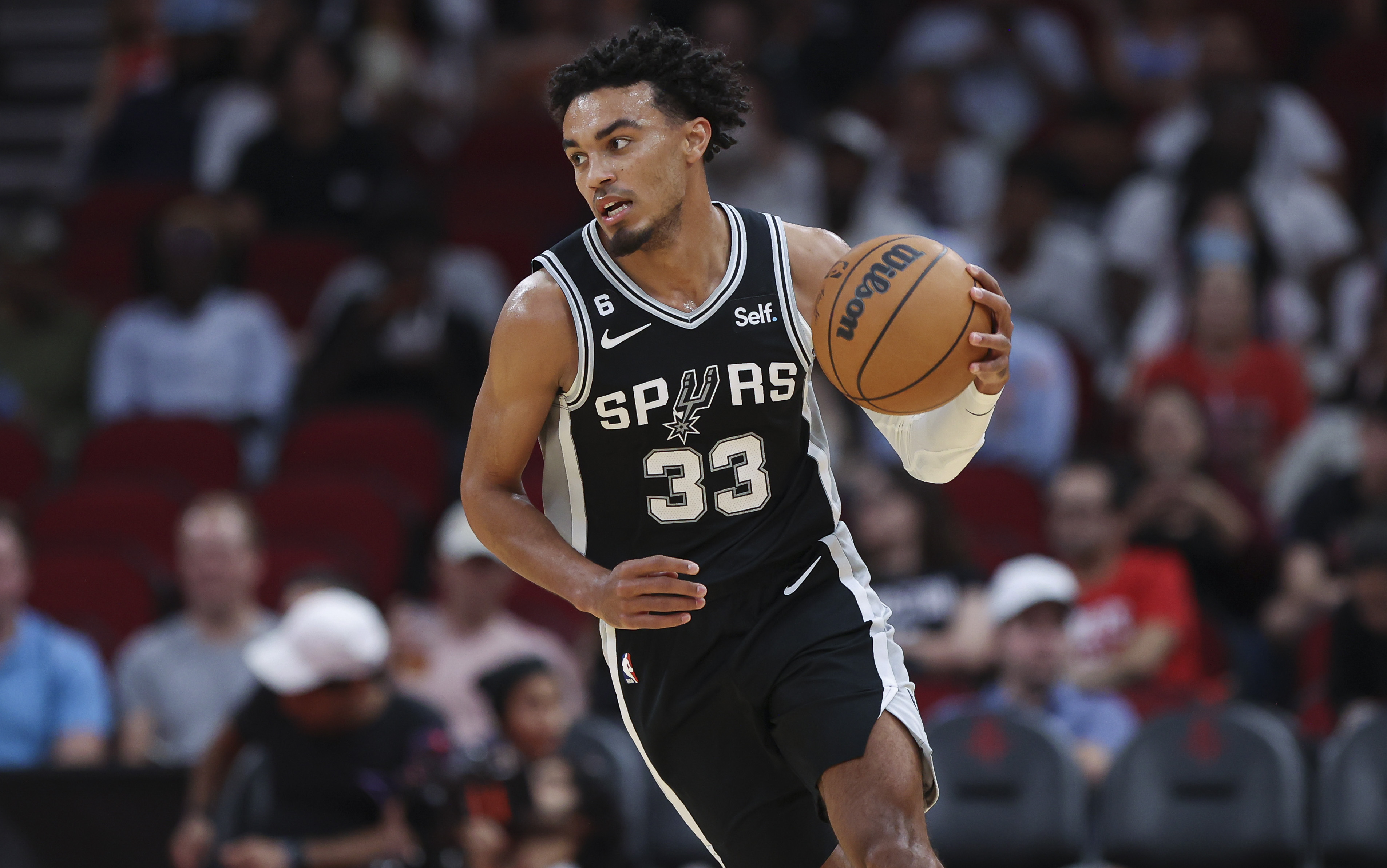 San Antonio Spurs point guard Tre Jones brings the ball up the floor. 