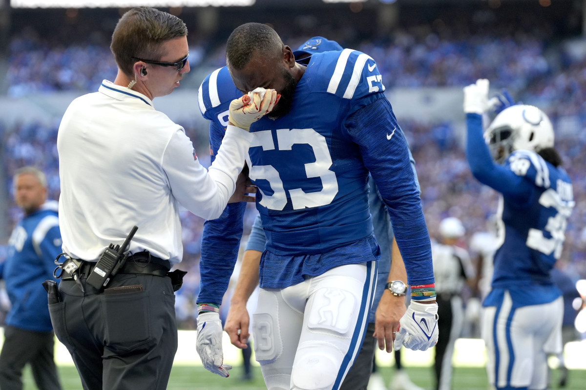 Oct 2, 2022; Indianapolis, Indiana, USA; Indianapolis Colts assistant athletic trainer Kyle Davis tends to linebacker Shaquille Leonard (53) after a play against the Tennessee Titans during the first half at Lucas Oil Stadium.