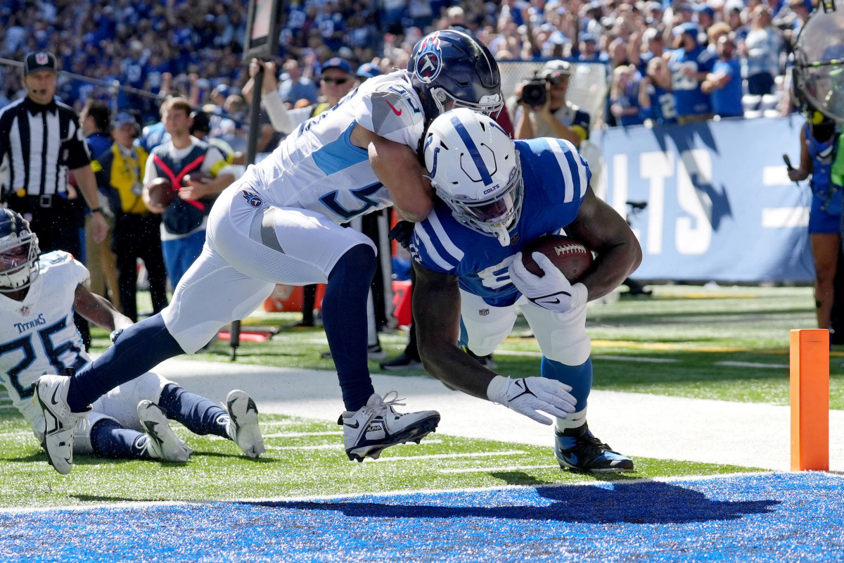 Oct 2, 2022; Indianapolis, Indiana, USA; Indianapolis Colts tight end Mo Alie-Cox (81) scores a touchdown while defended by Tennessee Titans linebacker Dylan Cole (53) during the first half at Lucas Oil Stadium.