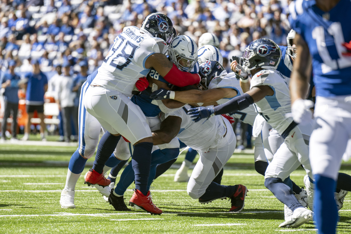 Oct 2, 2022; Indianapolis, Indiana, USA; Indianapolis Colts running back Jonathan Taylor (28) is tackled by multiple Tennessee Titans during the second quarter at Lucas Oil Stadium.