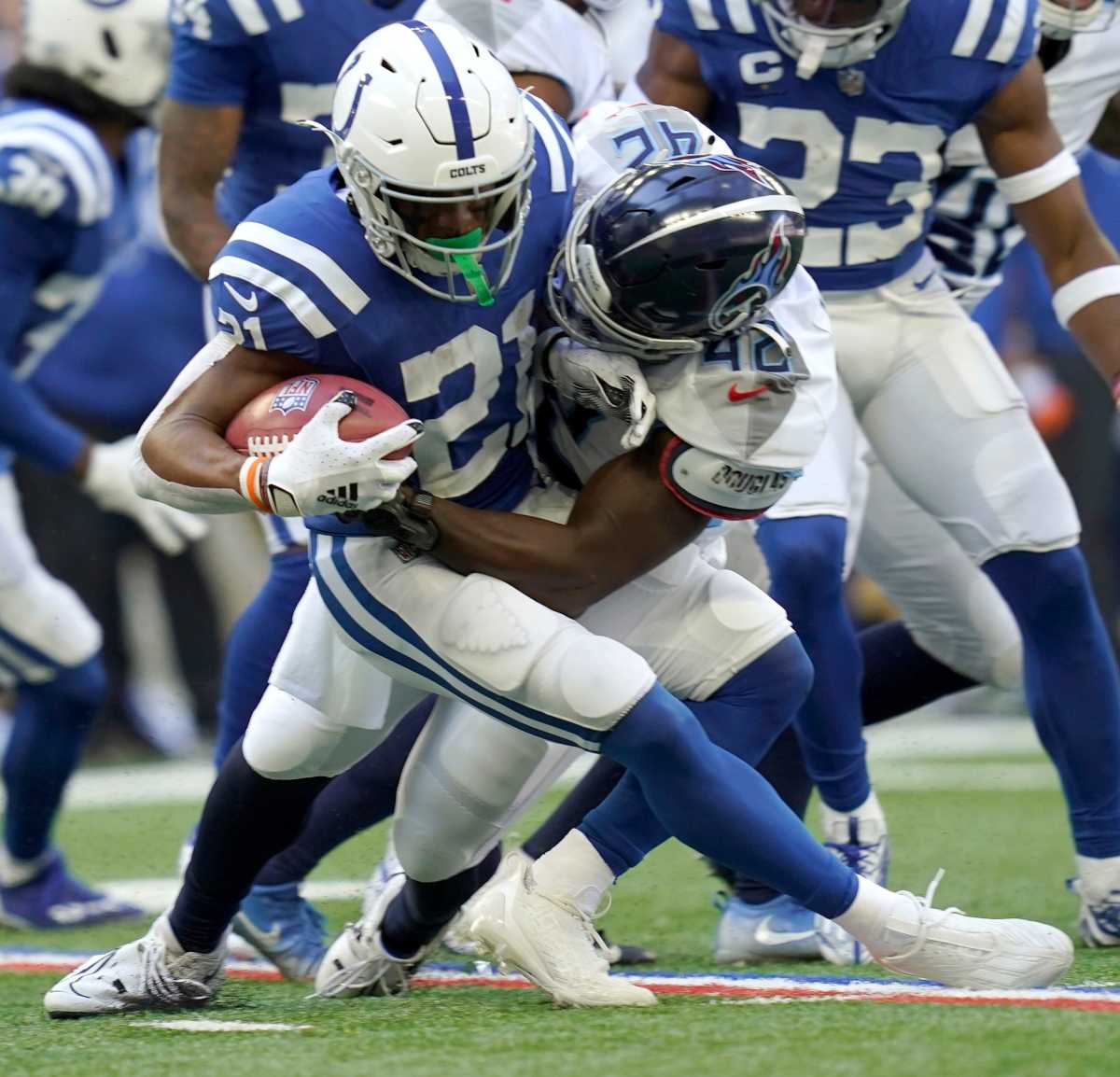Tennessee Titans linebacker Joe Jones (42) tackles Indianapolis Colts running back Nyheim Hines (21) on Sunday, Oct. 2, 2022, during a game against the Tennessee Titans at Lucas Oil Stadium in Indianapolis.