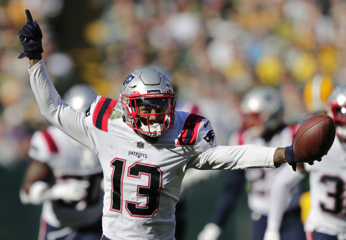 Oct 2, 2022; Green Bay, Wisconsin, USA; New England Patriots cornerback Jack Jones (13) celebrates after recovering a fumble by Green Bay Packers wide receiver Romeo Doubs (not pictured) at Lambeau Field.