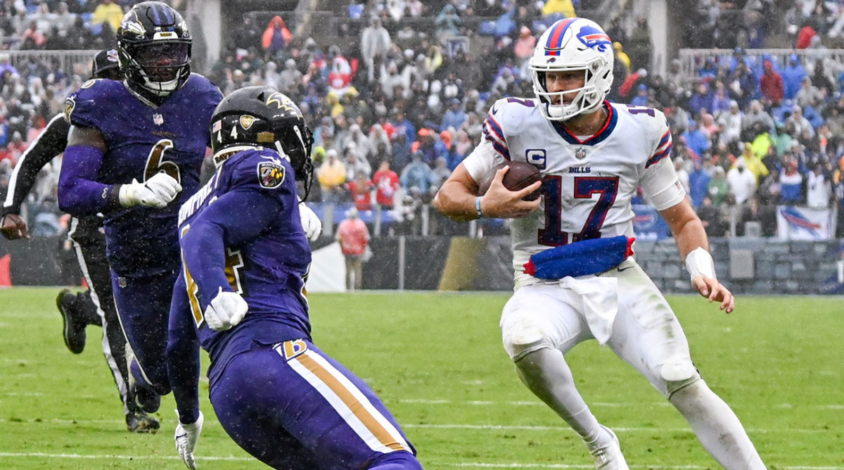 Josh Allen looks for a place to run in the rain against the Ravens.