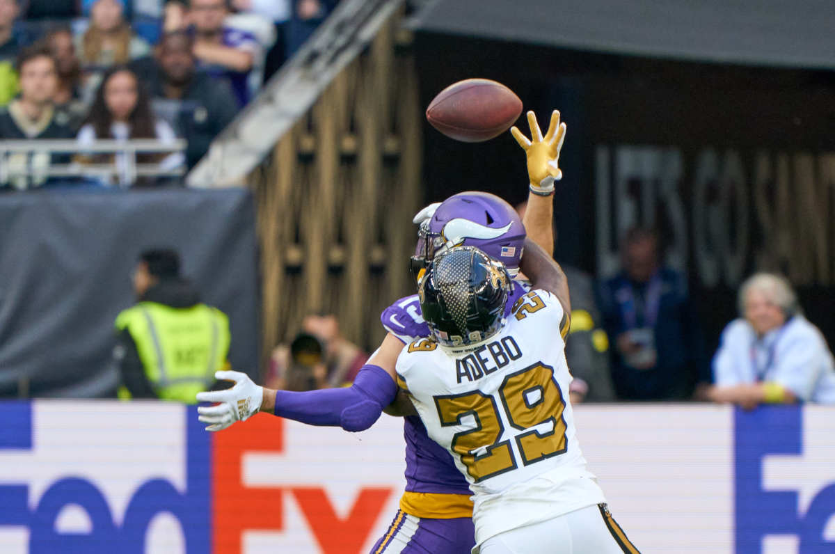 Minnesota Vikings wide receiver Adam Thielen (19) catches a pass under pressure from New Orleans Saints cornerback Paulson Adebo (29) during the second half of the NFL International Series game at Tottenham Hotspur Stadium
