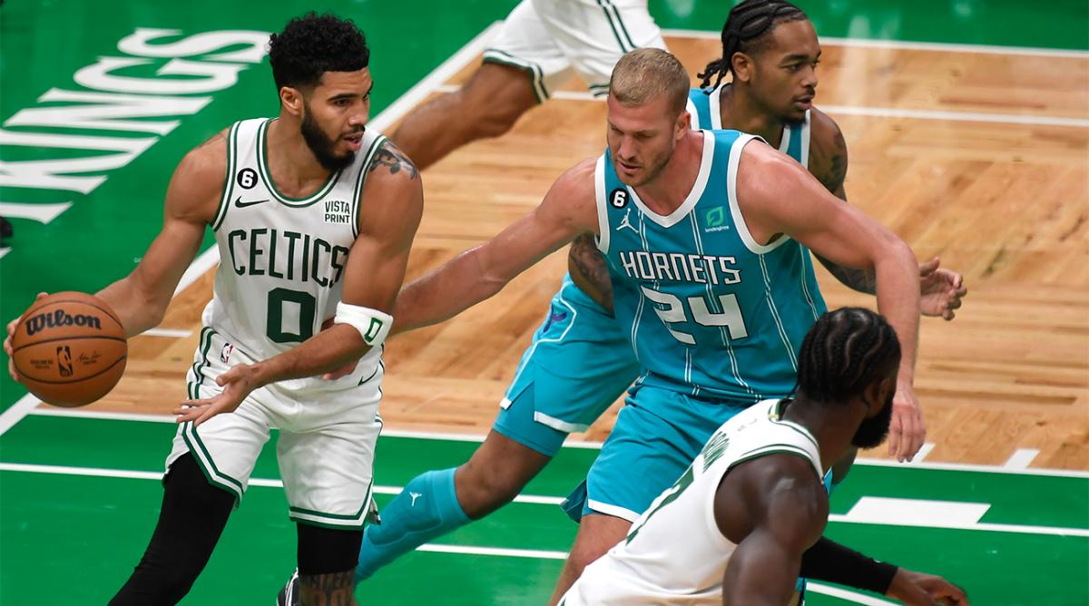 Oct 2, 2022; Boston, Massachusetts, USA; Boston Celtics forward Jayson Tatum (0) controls the ball while Charlotte Hornets center Mason Plumlee (24) defends during the first half at TD Garden.