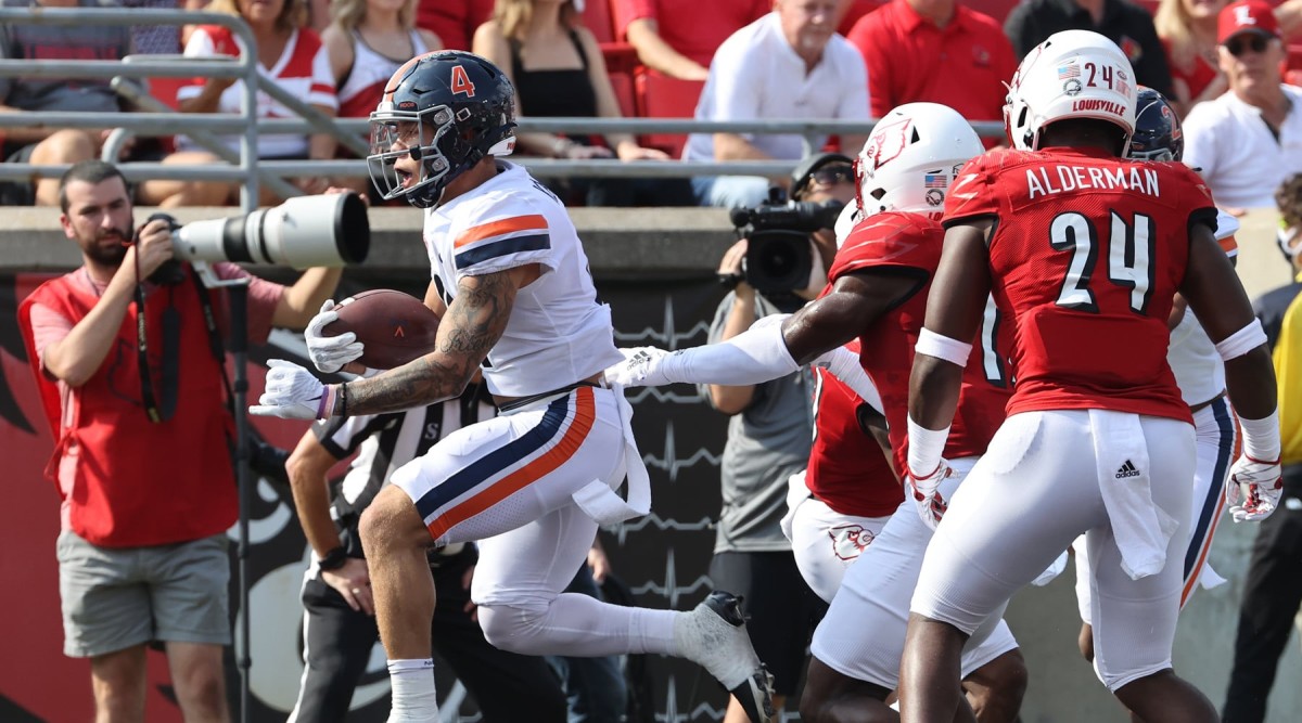Virginia Cavaliers receiver Billy Kemp IV scores a touchdown against the Louisville Cardinals.