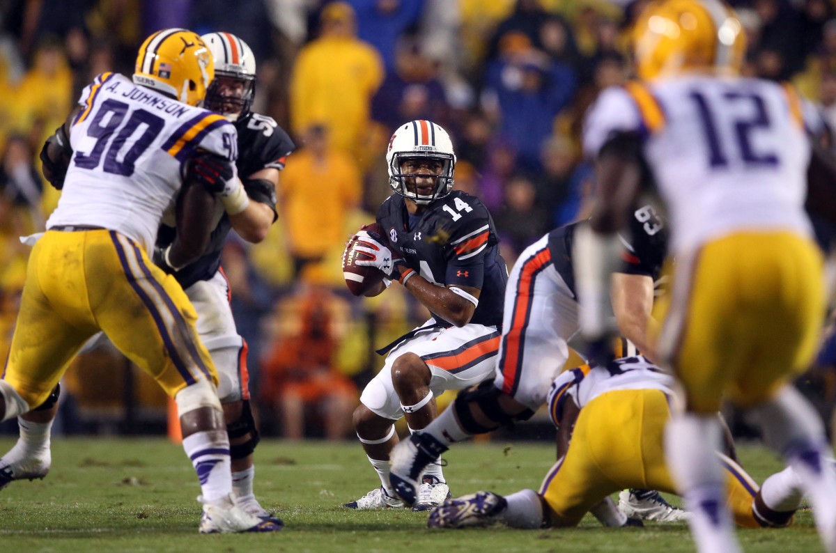 Sep 21, 2013; Baton Rouge, LA, USA; Auburn Tigers quarterback Nick Marshall (14) looks to pass the ball against the LSU Tigers in the first quarter at Tiger Stadium. Mandatory Credit: Crystal LoGiudice-USA TODAY Sports