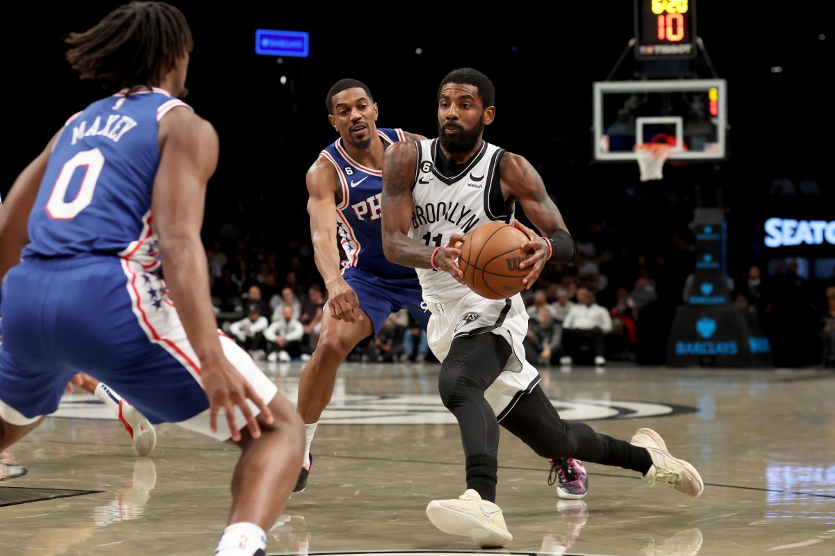Sixers' De'Anthony Melton and Tyrese Maxey guarding Nets' Kyrie Irving.