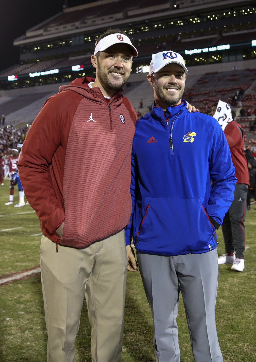 Oklahoma Sooners head coach Lincoln Riley (left) takes a photo with his brother Kansas Jayhawks offensive analyst Garrett Riley after the game at Gaylord Family - Oklahoma Memorial Stadium