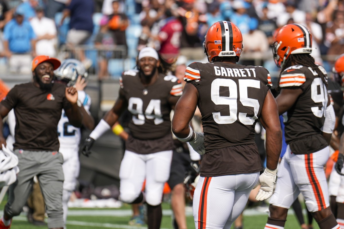 Sep 11, 2022; Charlotte, North Carolina, USA; Cleveland Browns celebrate the close win as Cleveland Browns defensive end Myles Garrett (95) and defensive end Jadeveon Clowney (90) walk to the sideline during the second half against the Carolina Panthers at Bank of America Stadium. Mandatory Credit: Jim Dedmon-USA TODAY Sports