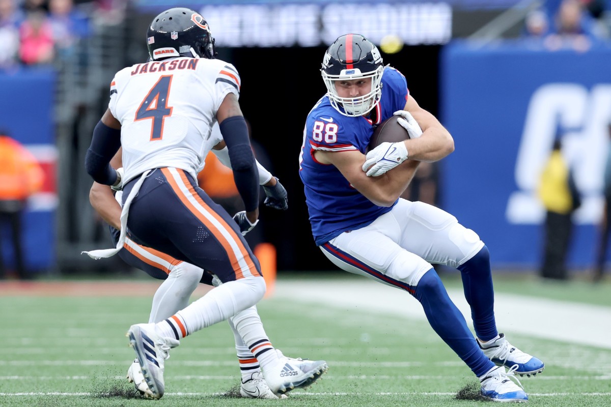 Oct 2, 2022; East Rutherford, New Jersey, USA; New York Giants tight end Tanner Hudson (88) runs with the ball against Chicago Bears safety Eddie Jackson (4) and cornerback Kyler Gordon (6) during the second quarter at MetLife Stadium.