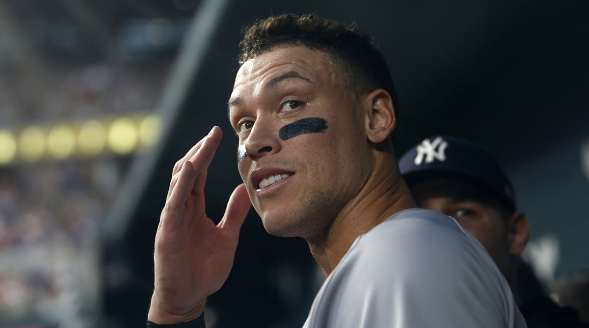 Yankees right fielder Aaron Judge (99) smiles in the dugout after hitting home run No. 62 to break the American League home run record in the first inning against the Rangers at Globe Life Field.