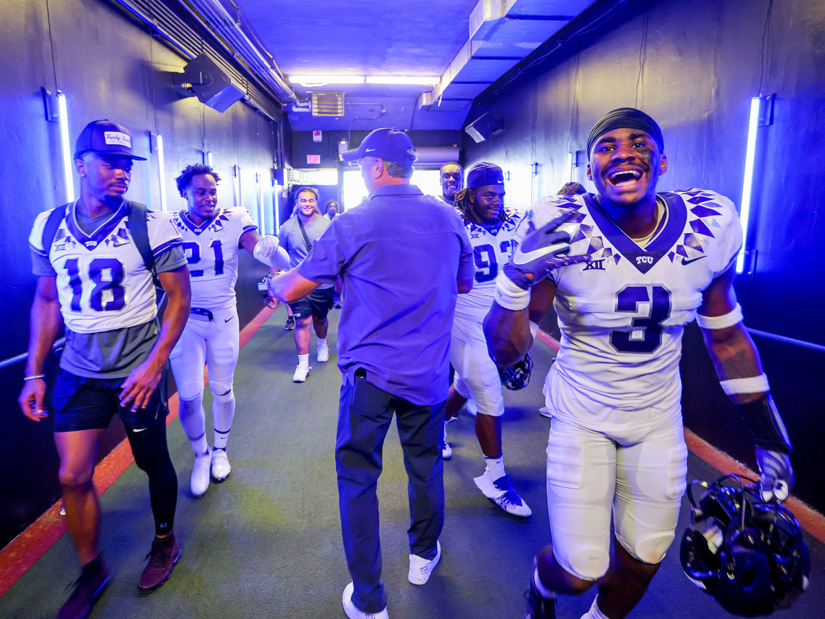 Sonny Dykes fist bumps TCU players after a win